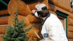 Chinking being applied to a log home